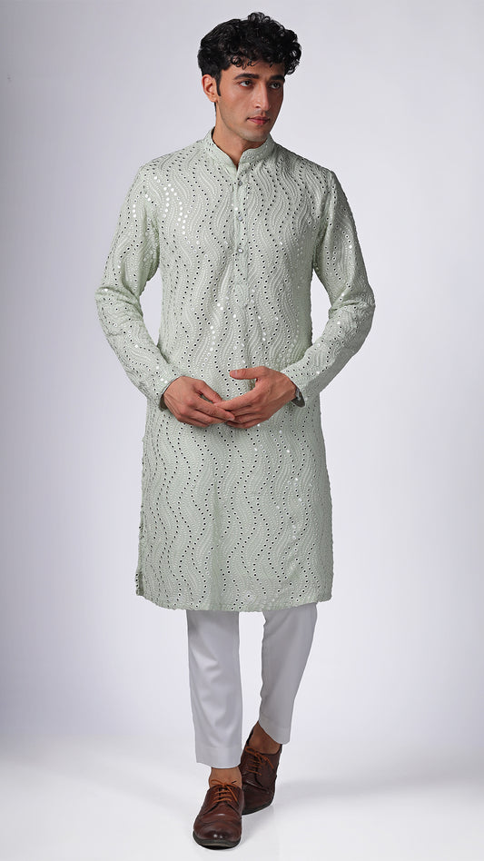 Model in Mint Green Kurta with Patterned Mirror Embroidery by BWO, paired with white slim trousers and white sneakers