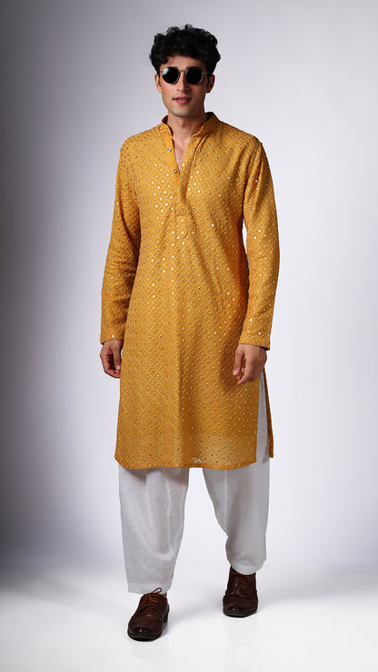 Model in Yellow Ochre Kurta with Boxed Mirror Accents by BWO, paired with salwar and tan Oxford shoes, wearing shades.