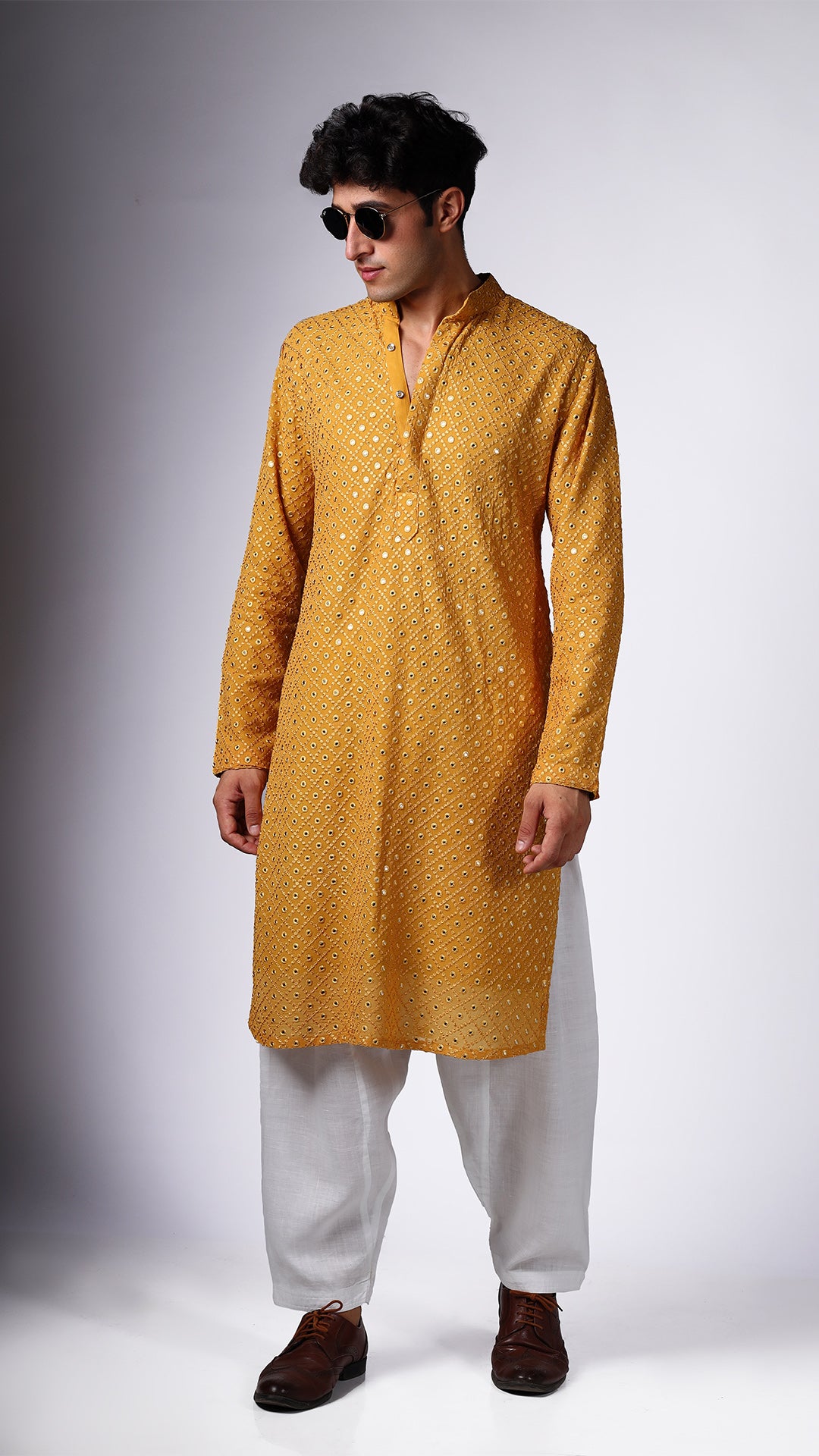 Different angle of Yellow Ochre Kurta, showcasing boxed mirror accents. Paired with salwar and shades