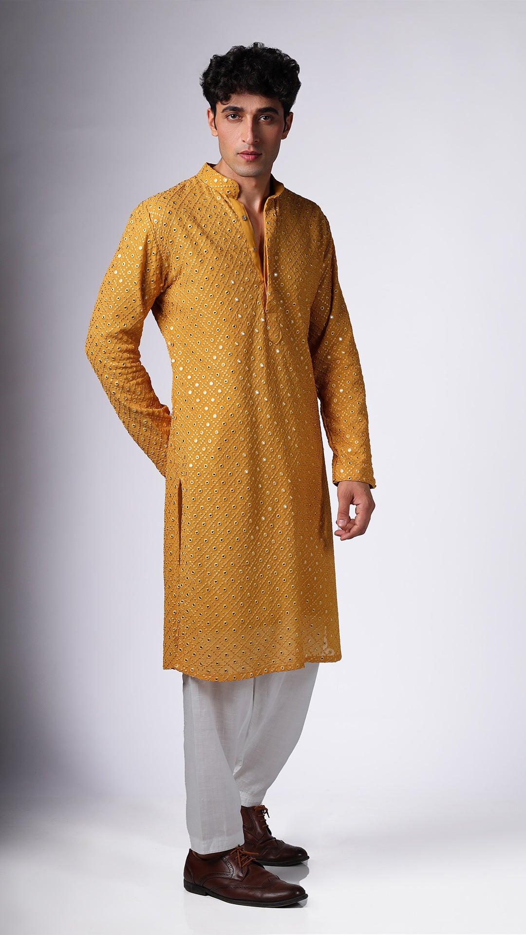 Side view of Yellow Ochre Kurta with Boxed Mirror Accents, worn with salwar and tan Oxford shoes