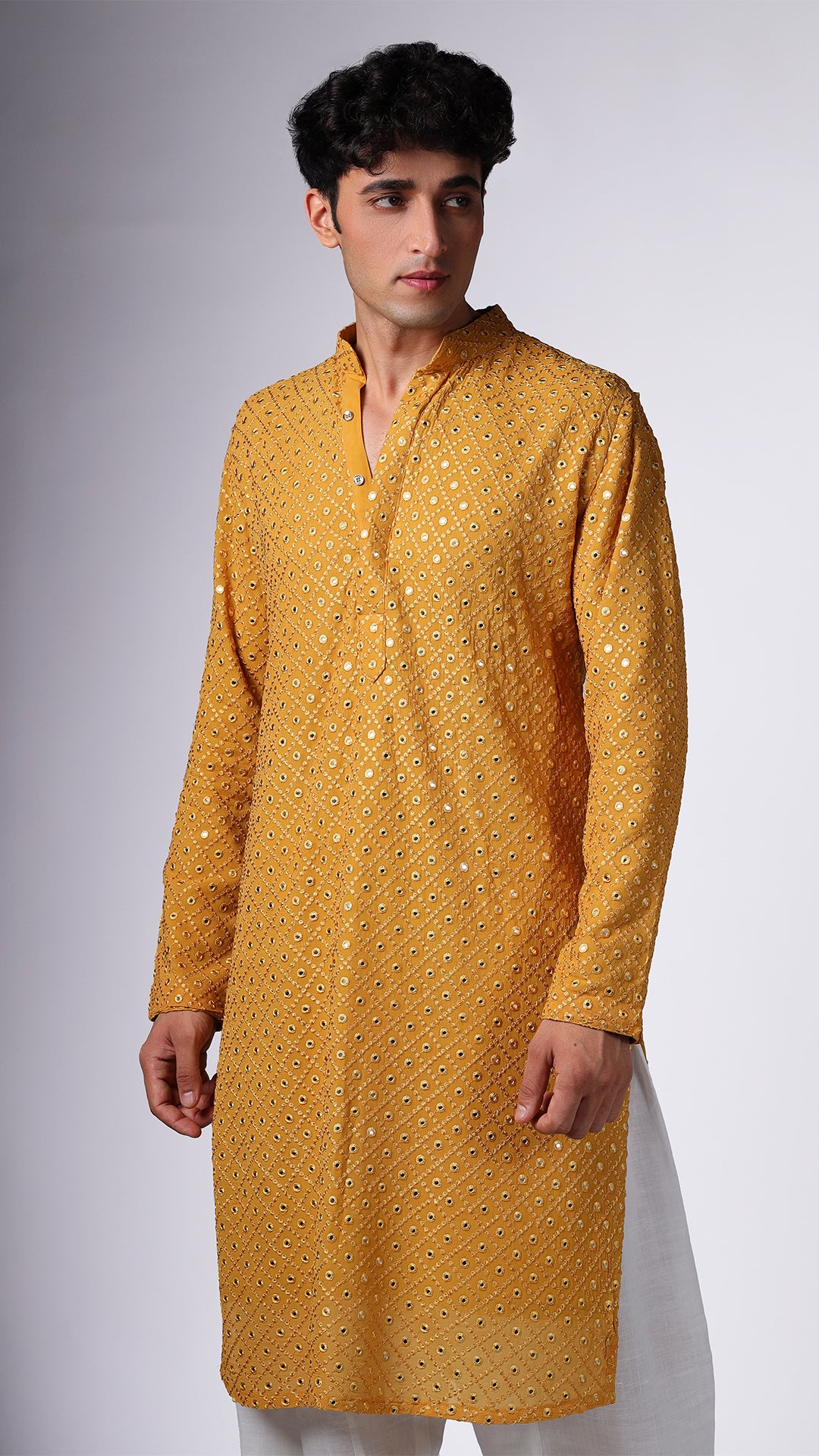 Close-up of Yellow Ochre Kurta with Boxed Mirror Accents, highlighting intricate details. Model styled with salwar