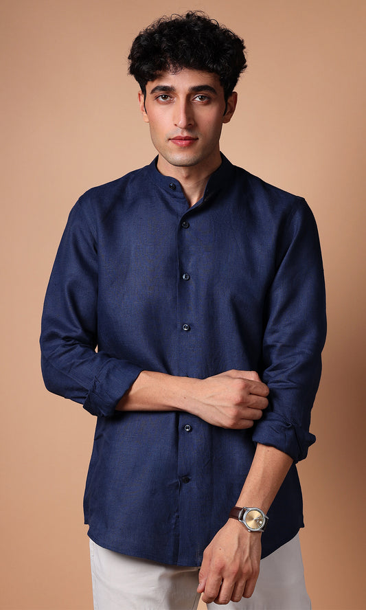 Navy blue linen shirt on a model, close-up to emphasize the deep blue tone and fabric detail.