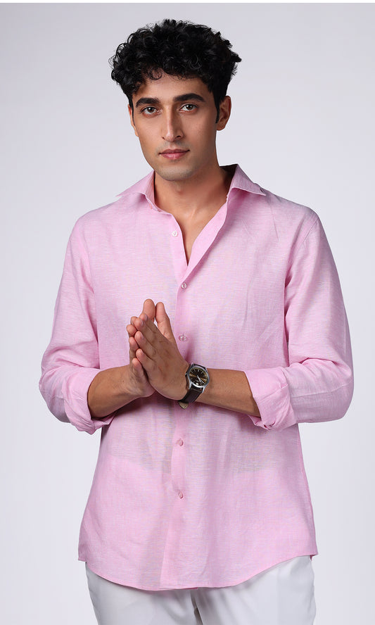 Model posing in a pink linen shirt, styled for a vibrant and youthful appearance.