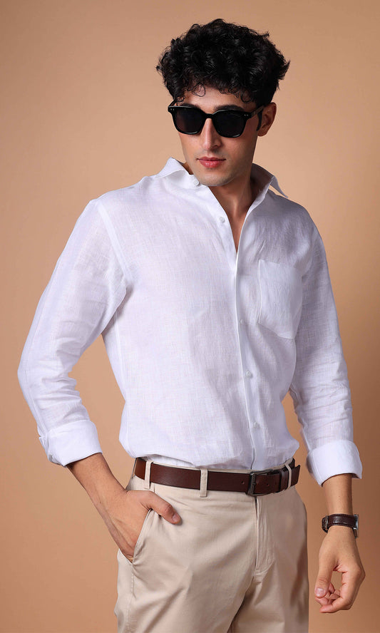 Model in a white linen shirt, posing with a confident stance, showcasing versatility.