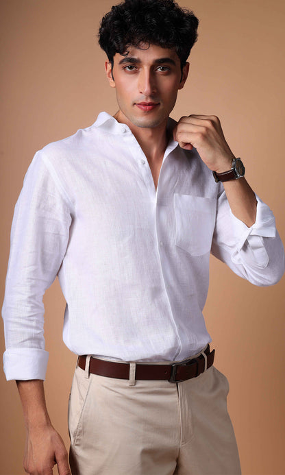 Model in a white linen shirt seen from the side, showing the garment's sleek silhouette